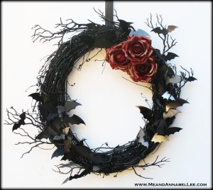 Combine a black grapevine wreath and paper bats to create this beautiful DIY Halloween Bat Wreath.... spooky decor for the front door of your Vampire Castle | The mirrored bats will give a haunting warm glow in the moonlight | Halloween Crafting | Me and Annabel Lee Blog