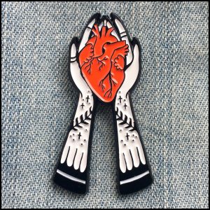Valentine Gift Guide - Dark, Curious, Gothic Valentine's Day and Anti Valentine gift ideas for him and for her | Tattooed Hands Holding Anatomical Heart Enamel Pin | Red Black Lapel Accessory | Me and Annabel Lee